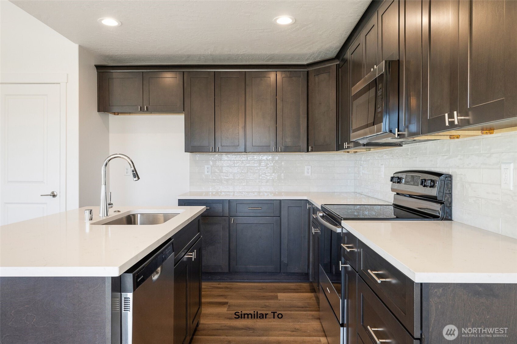 4251 Sandy Street Moses Lake, WA 98837 - Photo 13 of 19 a kitchen with a sink cabinets and stainless steel appliances