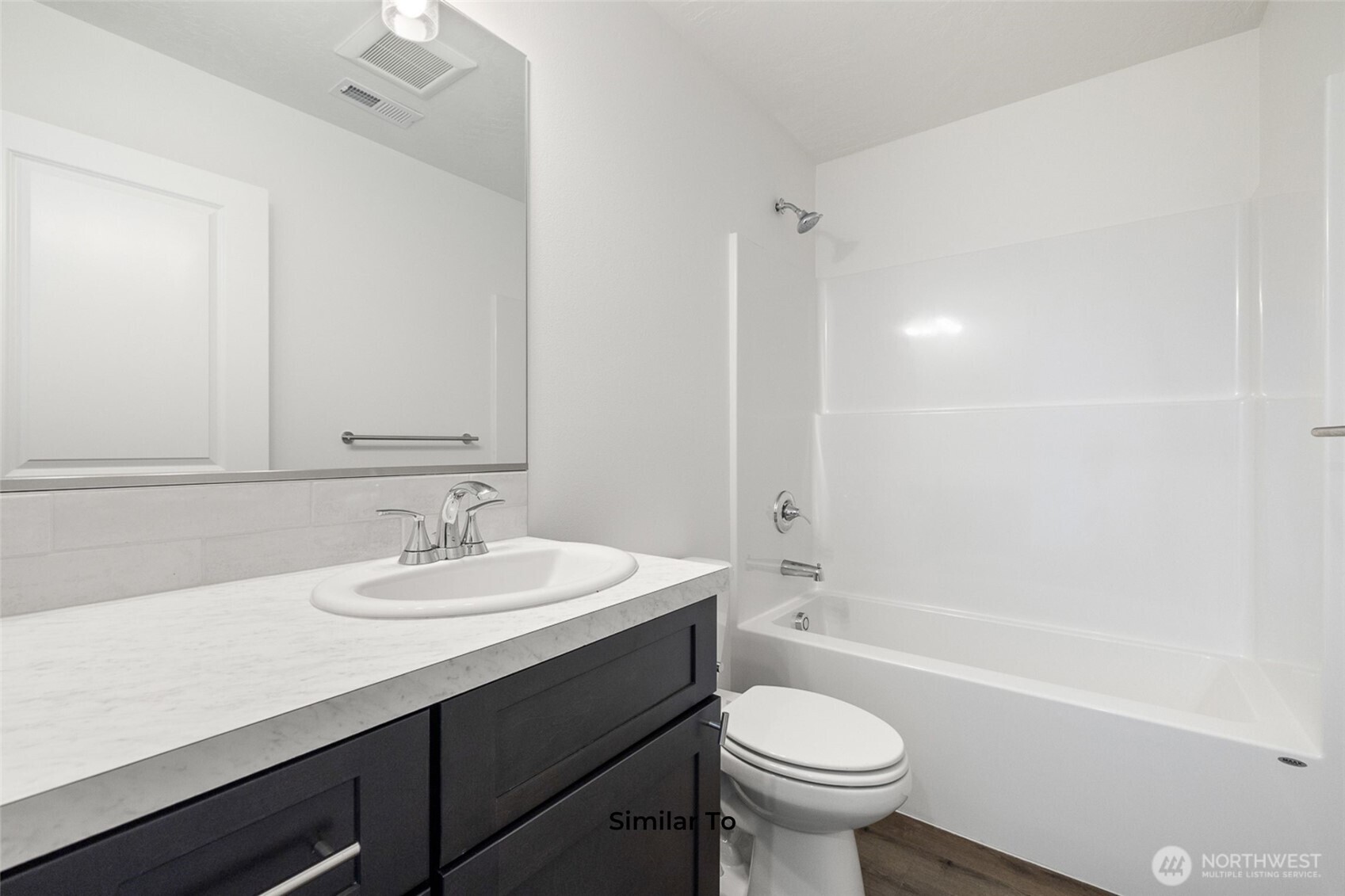 4251 Sandy Street Moses Lake, WA 98837 - Photo 18 of 19 a bathroom with a sink a toilet and a mirror