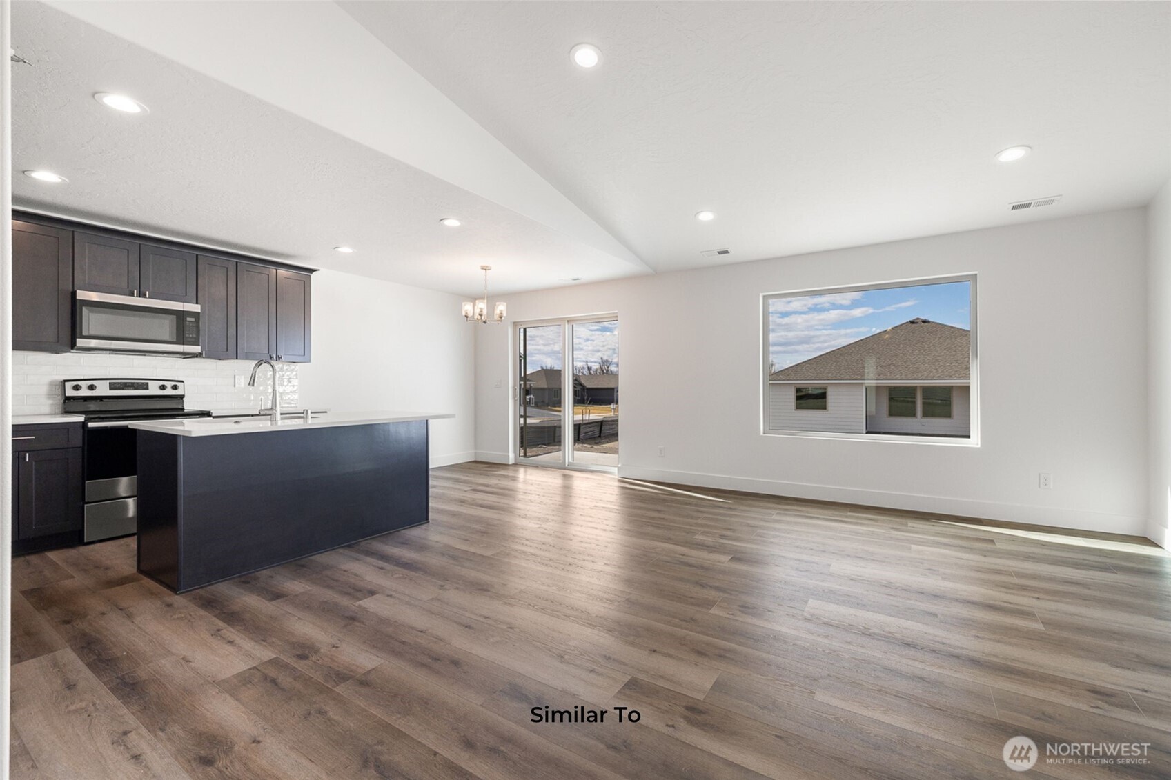 4251 Sandy Street Moses Lake, WA 98837 - Photo 19 of 19 a large kitchen with stainless steel appliances granite countertop a large counter top and oven