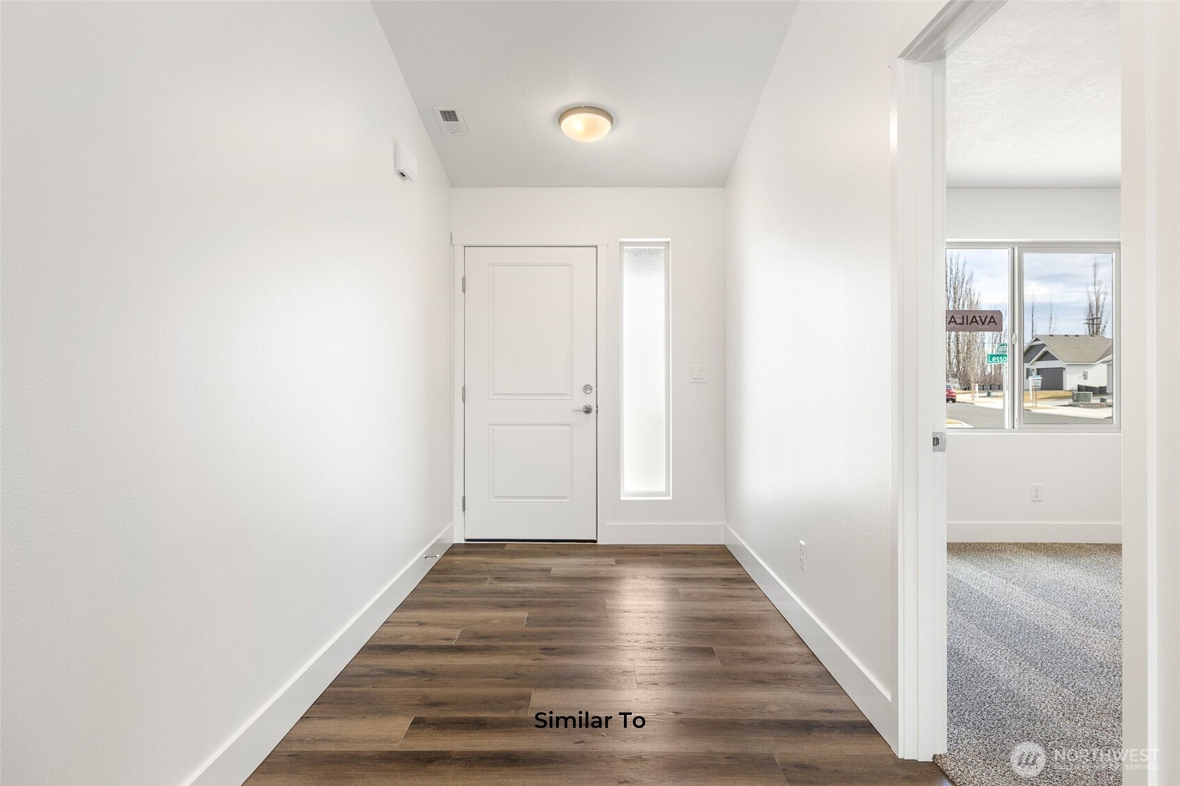 4251 Sandy Street Moses Lake, WA 98837 - Photo 3 of 19 a view of a hallway with wooden floor and closet