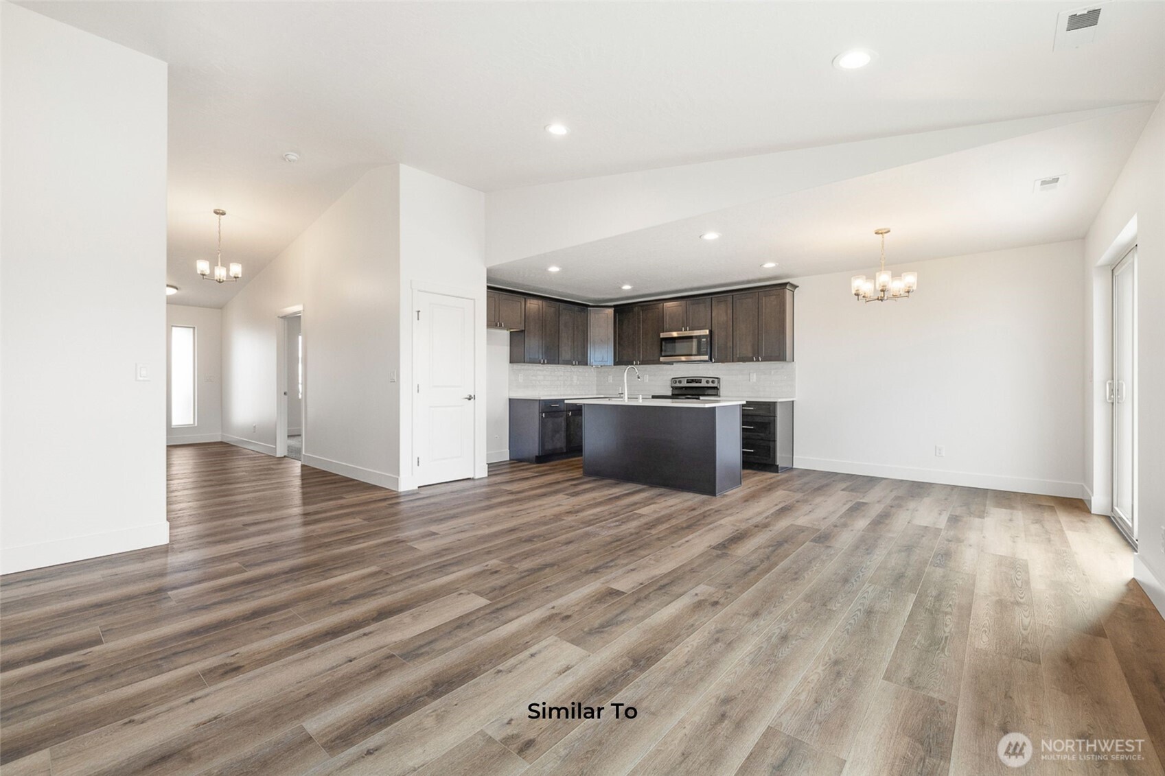 4251 Sandy Street Moses Lake, WA 98837 - Photo 9 of 19 a view of a kitchen with a sink and a refrigerator