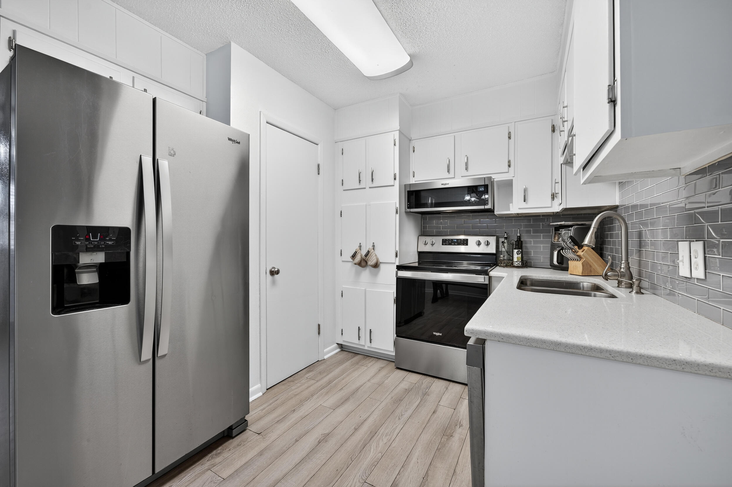 313 Brackin Street, Unit A Crestview, FL 32539 - Photo 11 of 28 a kitchen with stainless steel appliances a refrigerator stove and sink