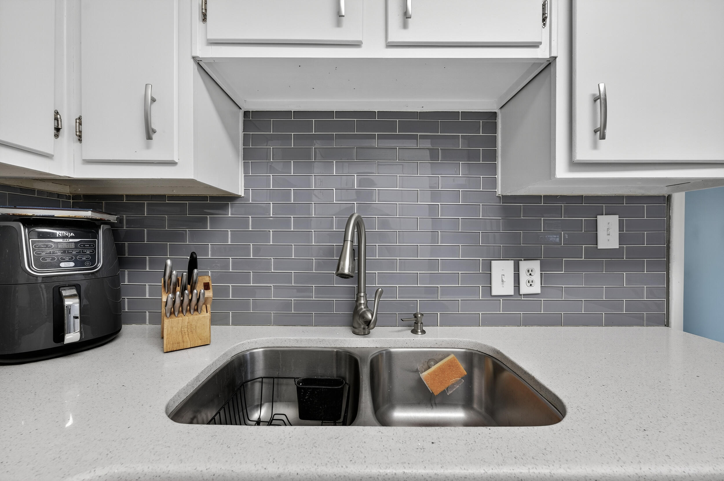 313 Brackin Street, Unit A Crestview, FL 32539 - Photo 12 of 28 a kitchen sink with granite countertop white cabinets