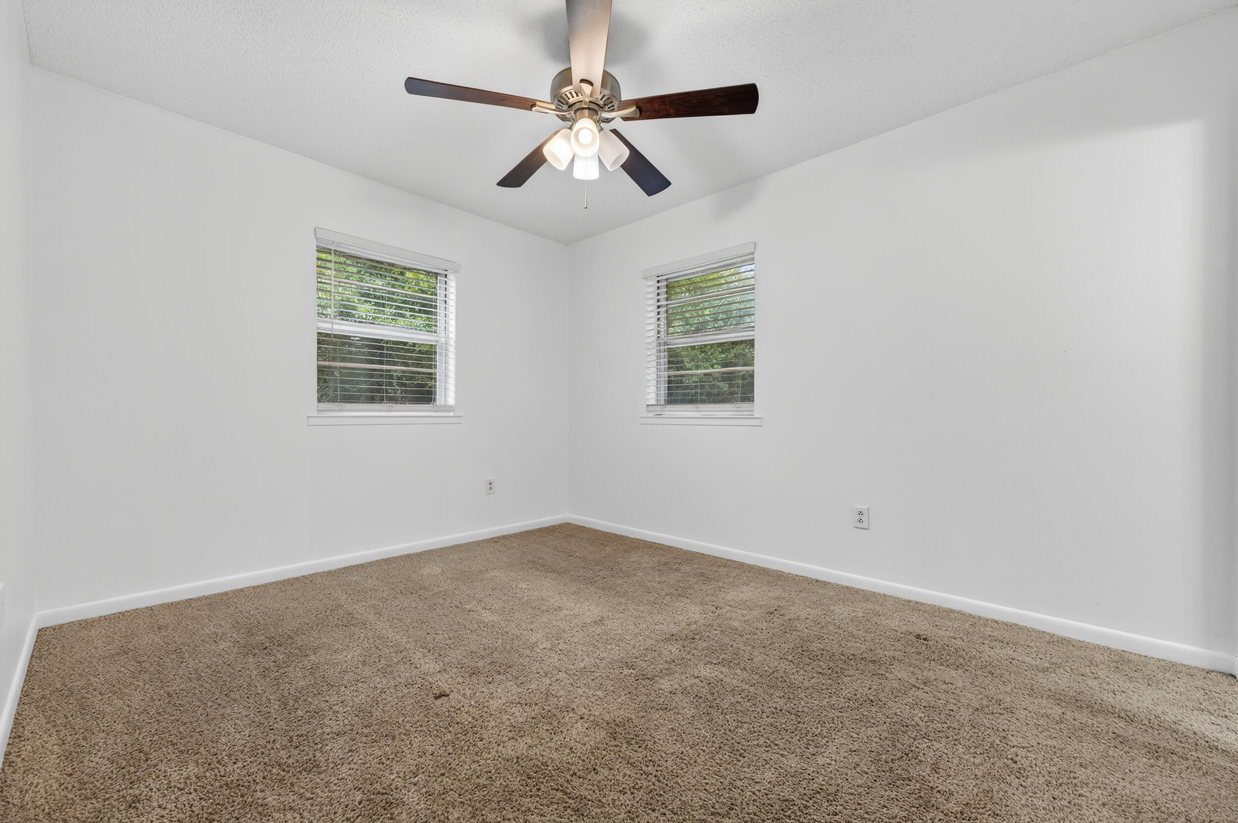 313 Brackin Street, Unit A Crestview, FL 32539 - Photo 17 of 28 an empty room with a window and a fan