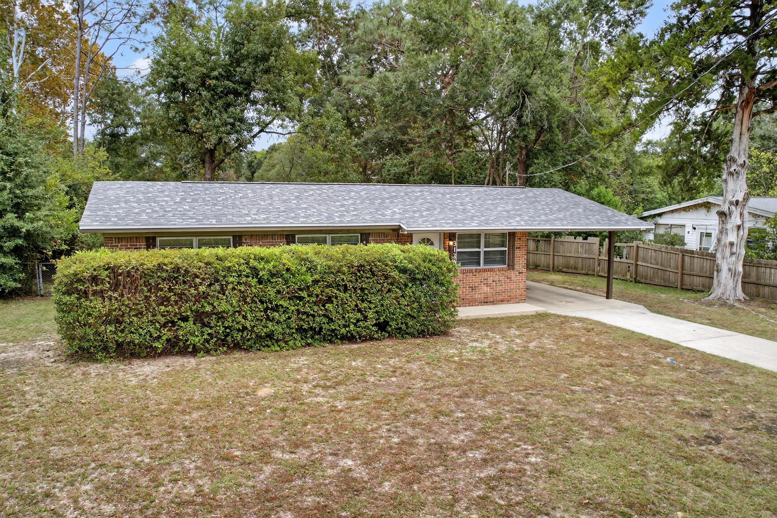 313 Brackin Street, Unit A Crestview, FL 32539 - Photo 2 of 28 a view of a garden with wooden fence