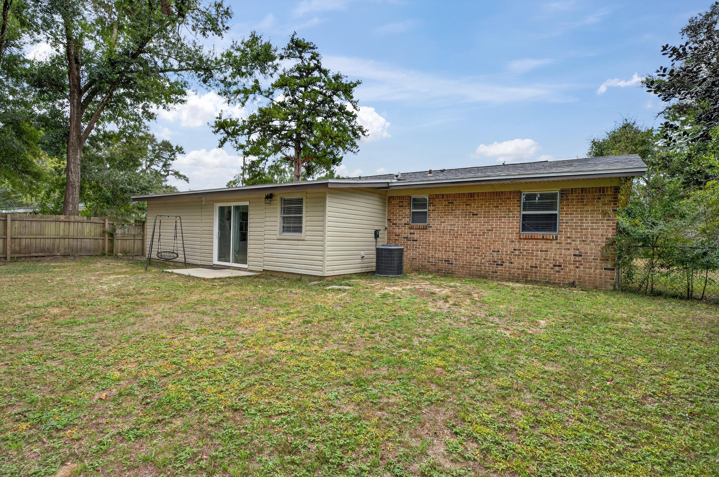 313 Brackin Street, Unit A Crestview, FL 32539 - Photo 27 of 28 a backyard of a house with lots of green space