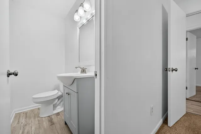 a bathroom with a sink a toilet and a mirror