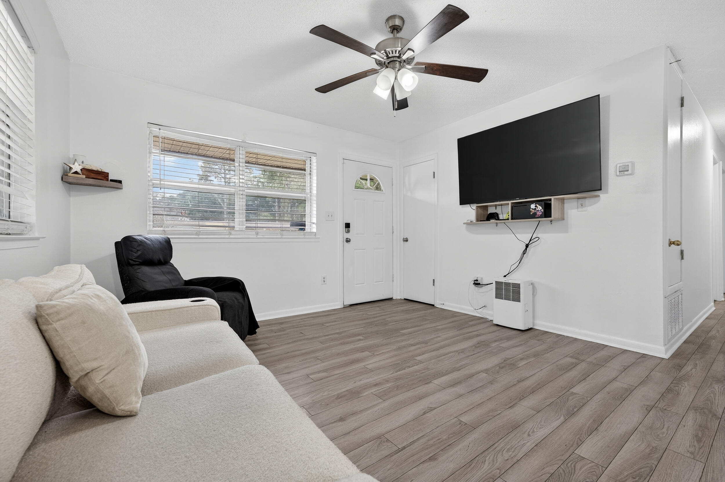 313 Brackin Street, Unit A Crestview, FL 32539 - Photo 5 of 28 a living room with furniture and a flat screen tv