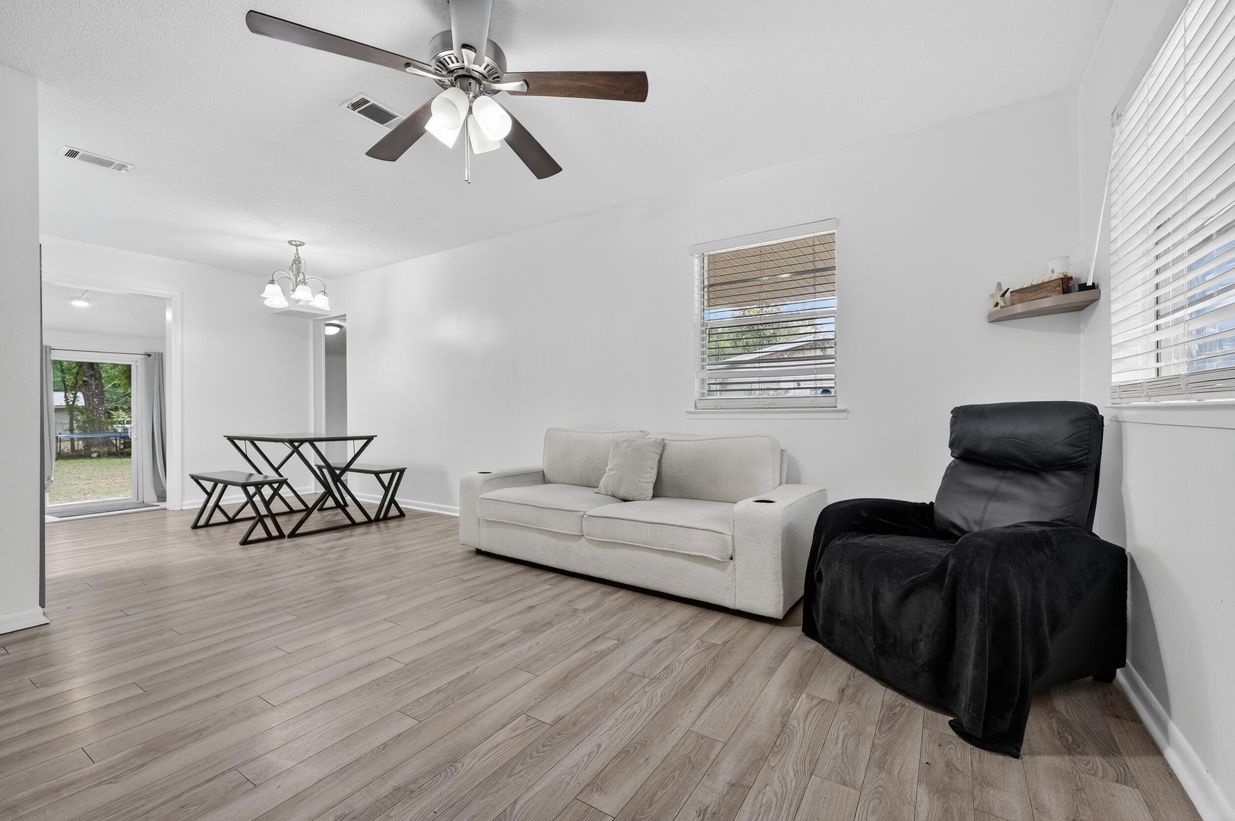 313 Brackin Street, Unit A Crestview, FL 32539 - Photo 7 of 28 a living room with furniture and a wooden floor