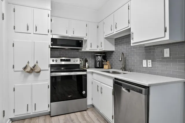 a kitchen with stainless steel appliances a refrigerator stove and sink