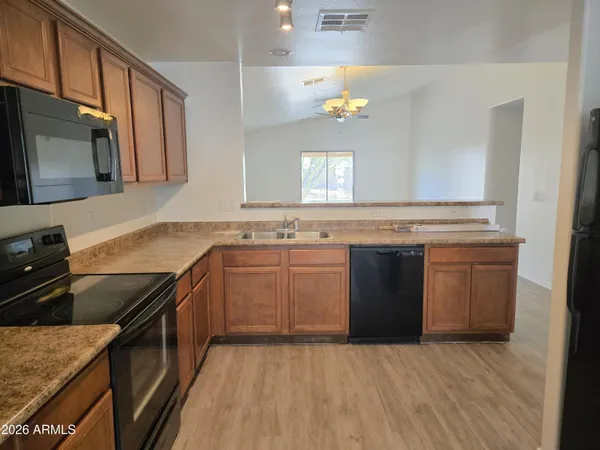 a kitchen with a sink stove and wooden cabinets