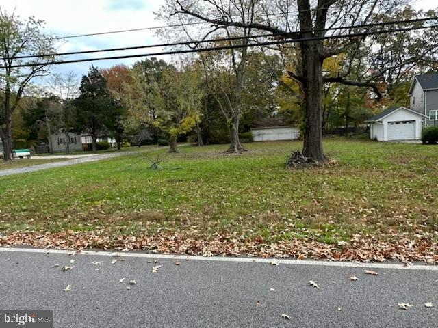797 Masons Beach Road Deale, MD 20751 - Photo 1 of 1 a view of a yard with a street sign and a tree