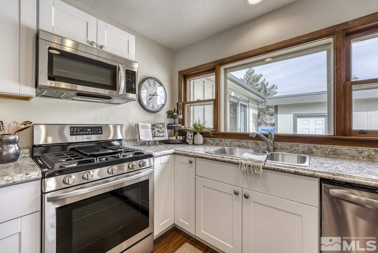 990 Yori Avenue Reno, NV 89502 - Photo 16 of 40 a kitchen with stainless steel appliances a stove a sink and a microwave