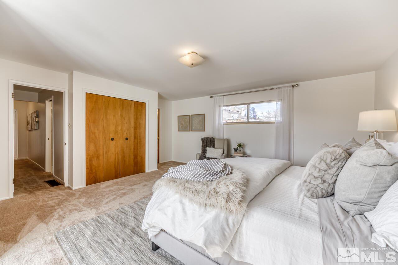 990 Yori Avenue Reno, NV 89502 - Photo 27 of 40 a bedroom with a large bed and wooden floor