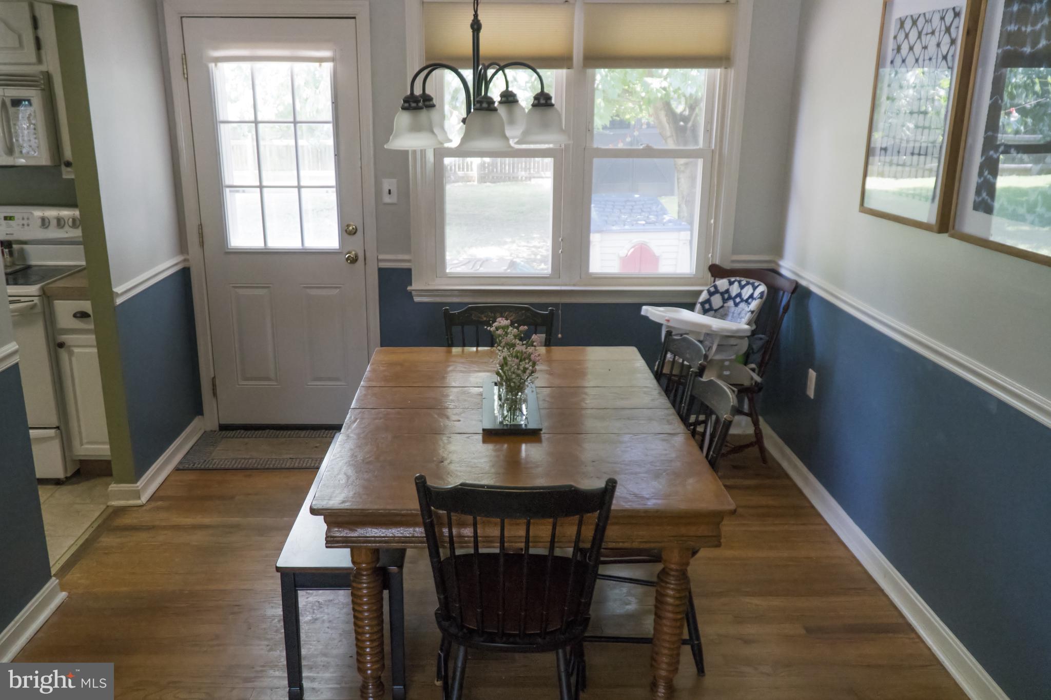 Dining Rm With Wood Floors & Access to Fenced Yard