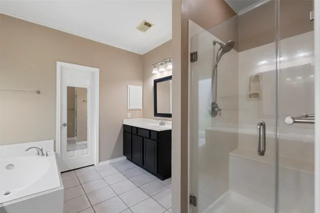 a view of an empty room with a window and kitchen view