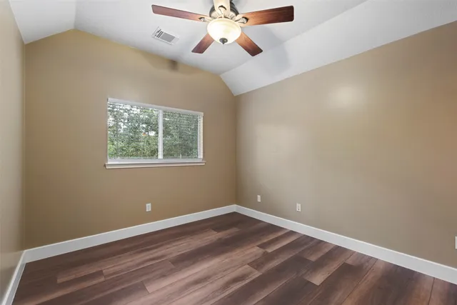a view of room with wooden floor