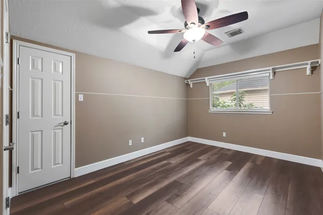 a bathroom with a tub sink vanity and mirror