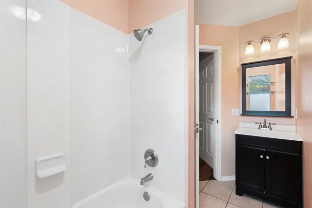 a bathroom with a tub and shower
