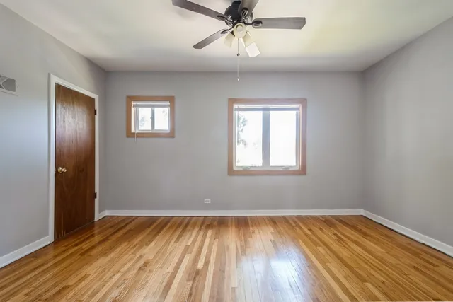 wooden floor in an empty room with a window