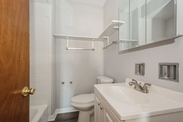 a bathroom with a sink toilet and vanity
