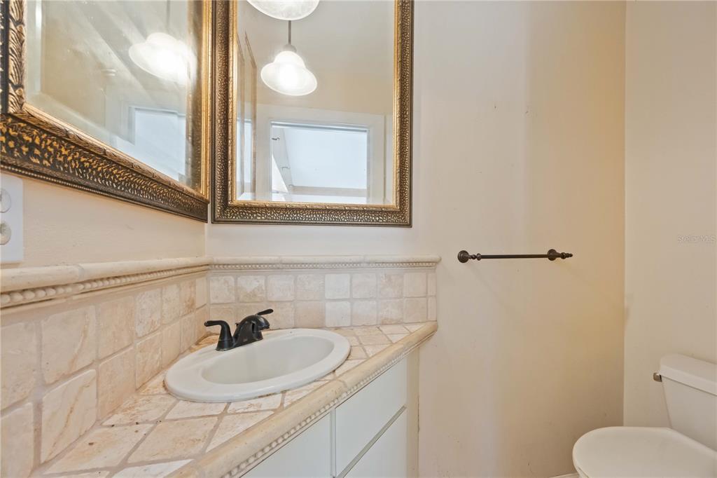 860 South Beneva Road Sarasota, FL 34232 - Photo 14 of 64 a bathroom with a toilet sink and mirror