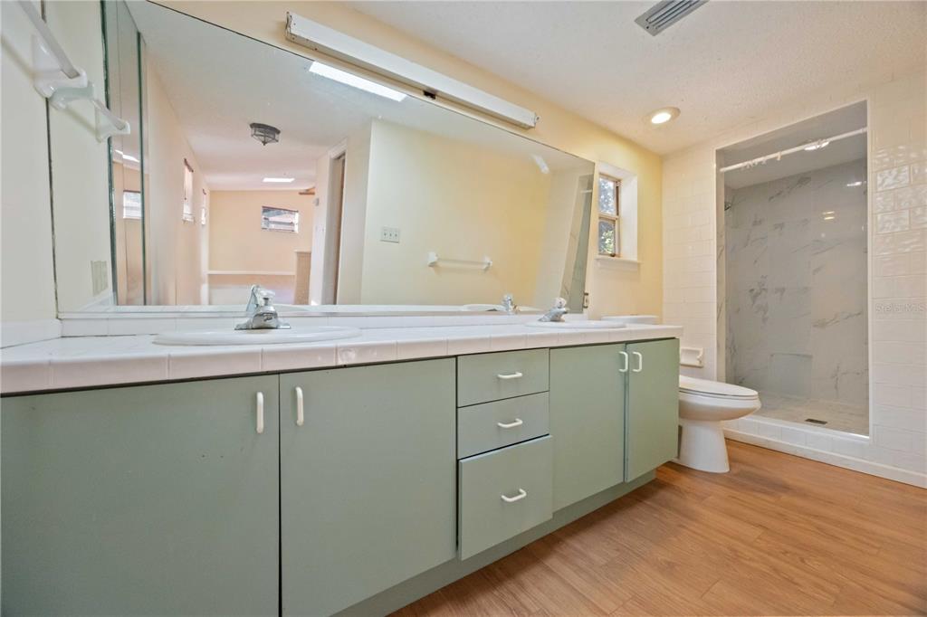 860 South Beneva Road Sarasota, FL 34232 - Photo 23 of 64 a bathroom with a granite countertop sink toilet a large mirror and shower
