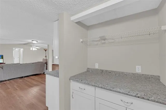 a view of a room with wooden floor and a window
