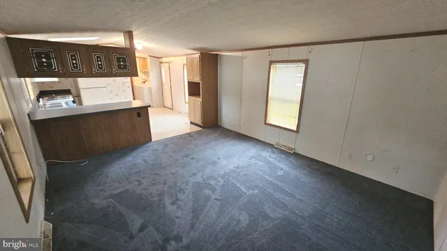 a view of a kitchen with an entryway and a window