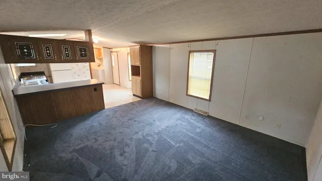 a view of a kitchen with furniture and window