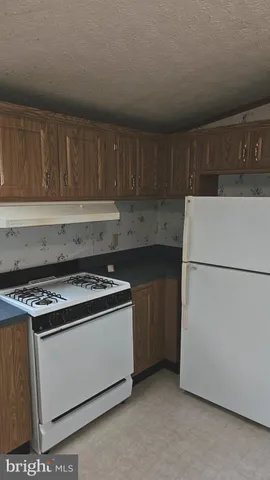 a kitchen with a stove and a refrigerator
