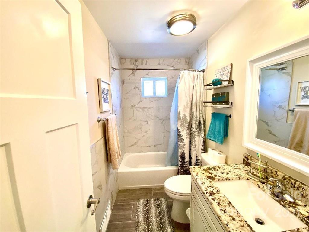 388 Union Cemetery Road Southwest Concord, NC 28027 - Photo 16 of 27 a bathroom with a bathtub shower sink vanity mirror and toilet