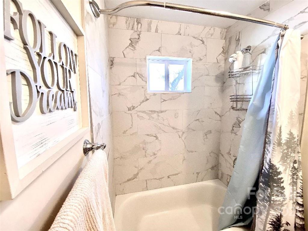 388 Union Cemetery Road Southwest Concord, NC 28027 - Photo 17 of 27 a bathroom with a bathtub and shower