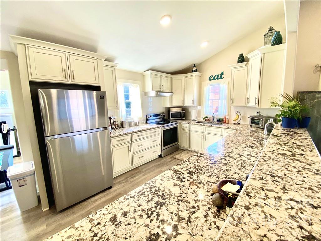 388 Union Cemetery Road Southwest Concord, NC 28027 - Photo 8 of 27 a kitchen with stainless steel appliances a refrigerator sink cabinets and a counter top space