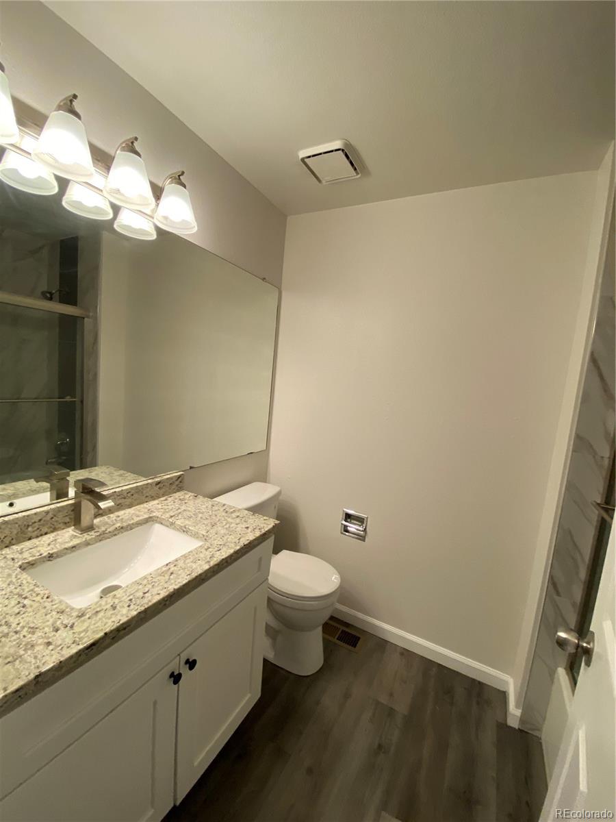 874 Homestead Drive Highlands Ranch, CO 80126 - Photo 11 of 13 a bathroom with a granite countertop sink a toilet and a mirror