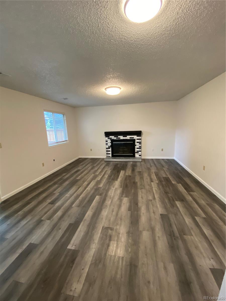 874 Homestead Drive Highlands Ranch, CO 80126 - Photo 7 of 13 a view of empty room with wooden floor