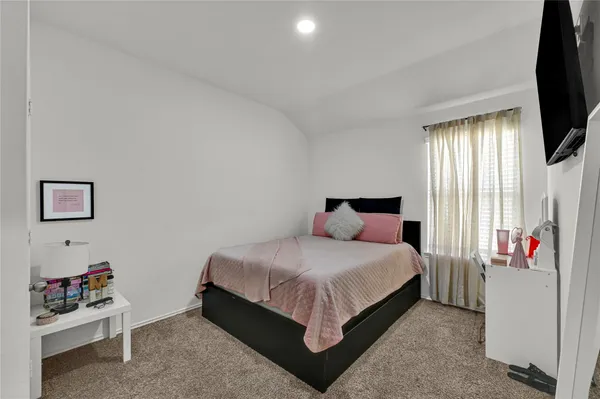 a bedroom with a bed and window