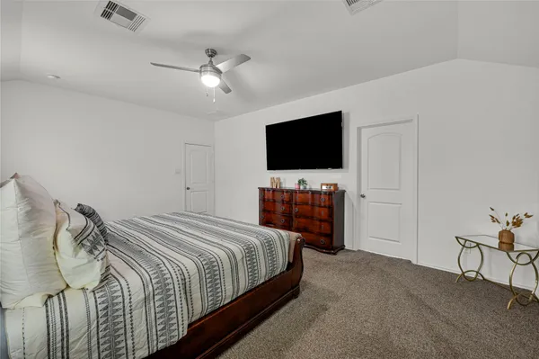 a bedroom with a bed and a flat screen tv
