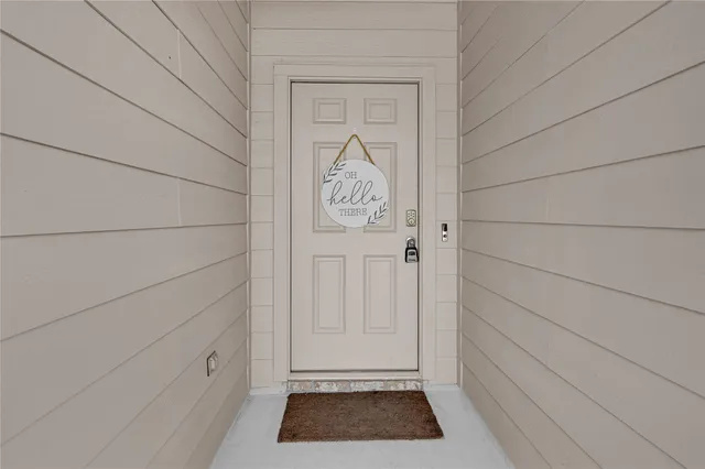 a view of front door with a rug