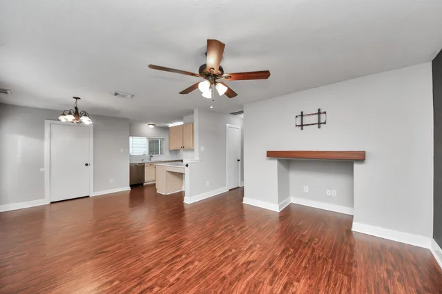 a kitchen with stainless steel appliances a refrigerator a stove top oven and wooden floors