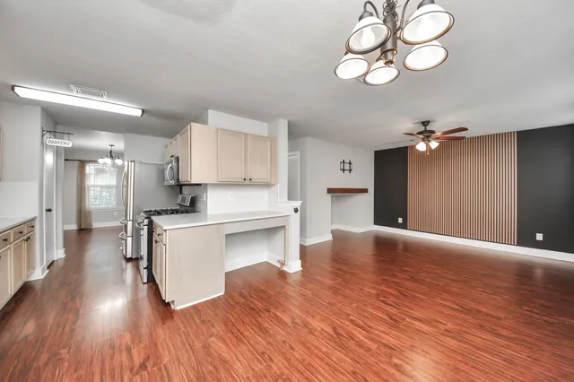 a kitchen with sink stove and cabinets