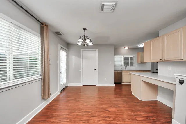 a kitchen with wooden floor a stove and a sink