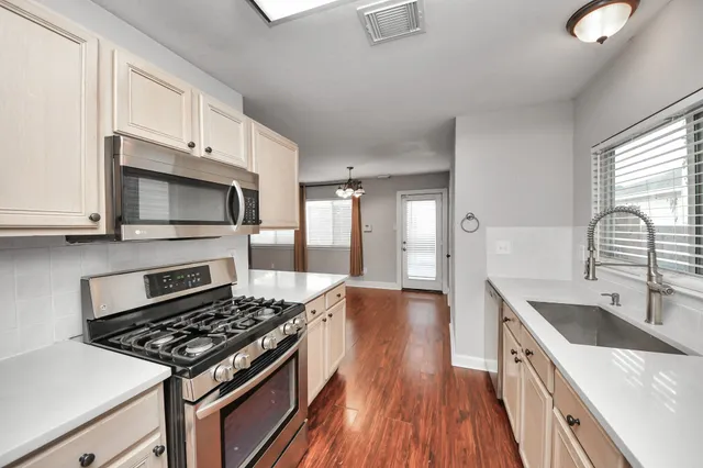 a bathroom with a granite countertop sink a large mirror and a bathtub