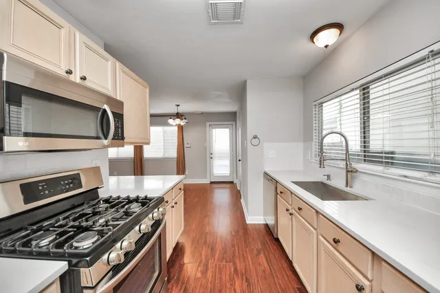 a bathroom with a tub sink and mirror