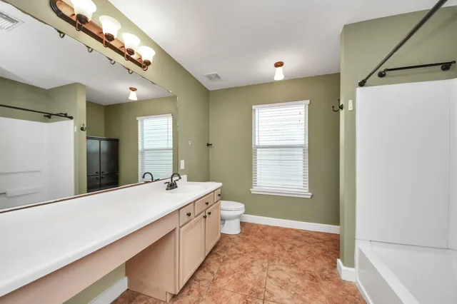 a view of an empty room and wooden floor