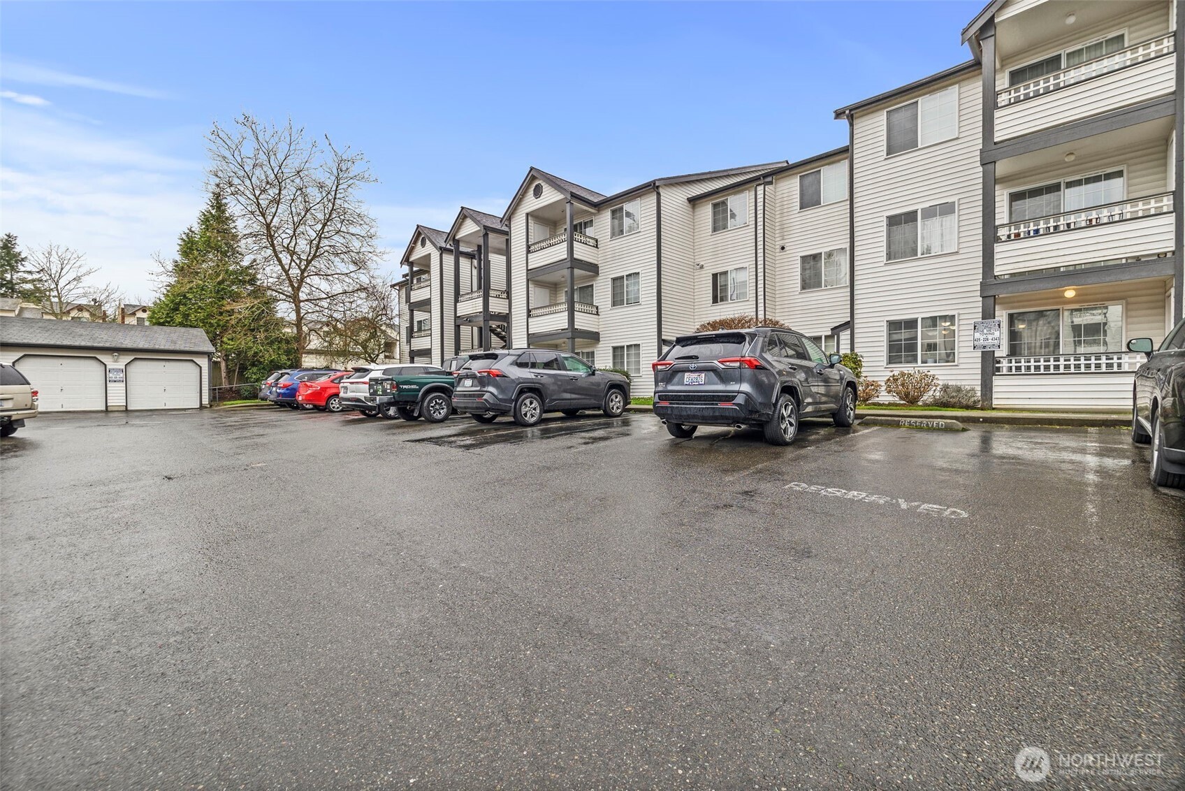 10824 Southeast 170th Street, Unit B103 Renton, WA 98055 - Photo 3 of 31 a parked cars is parked in front of a building
