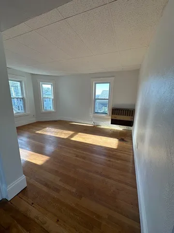a view of empty room with window and fireplace