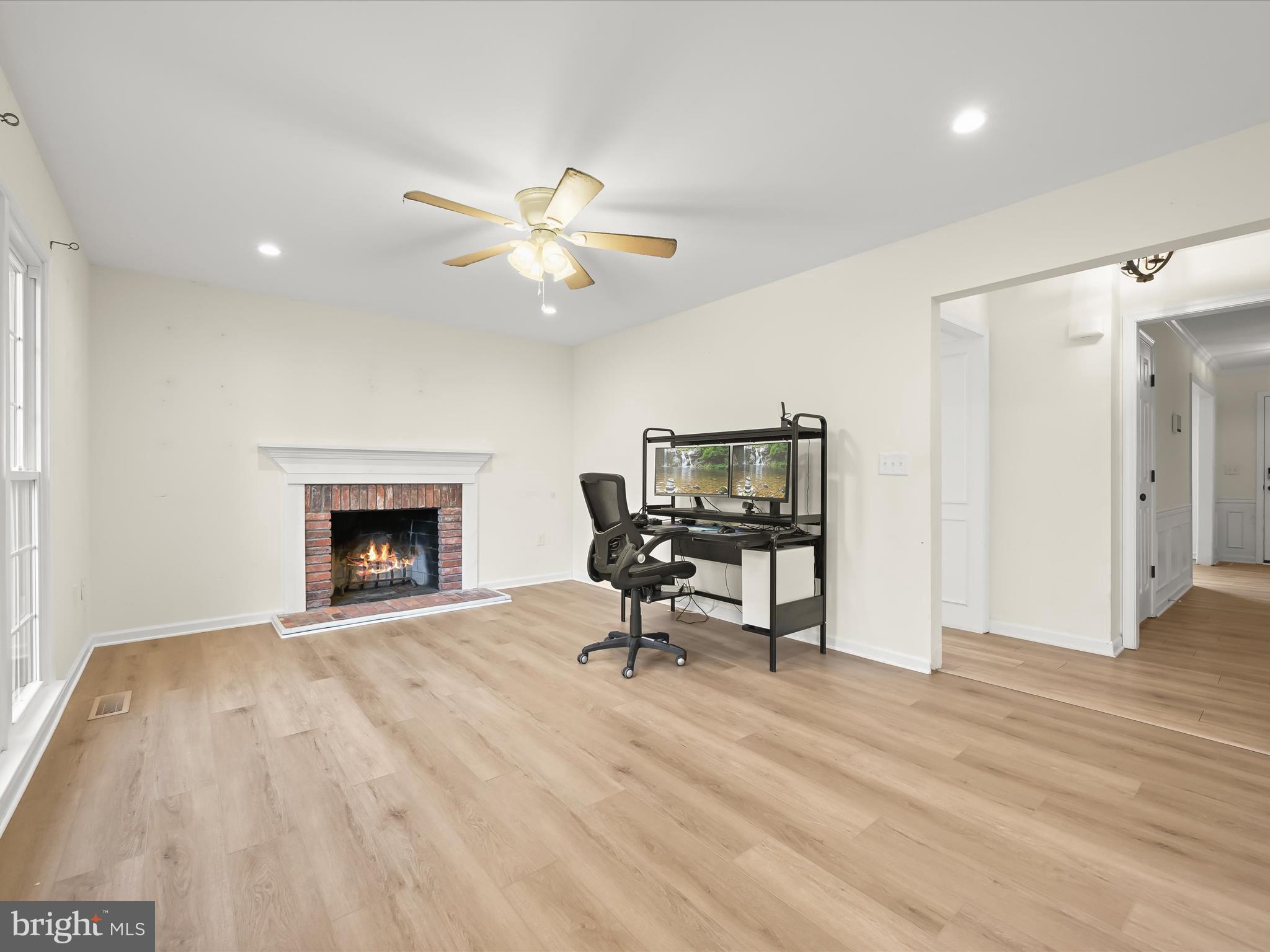 8806 Admiral Drive Laurel, MD 20708 - Photo 18 of 59 a view of a livingroom with a fireplace and a chandelier