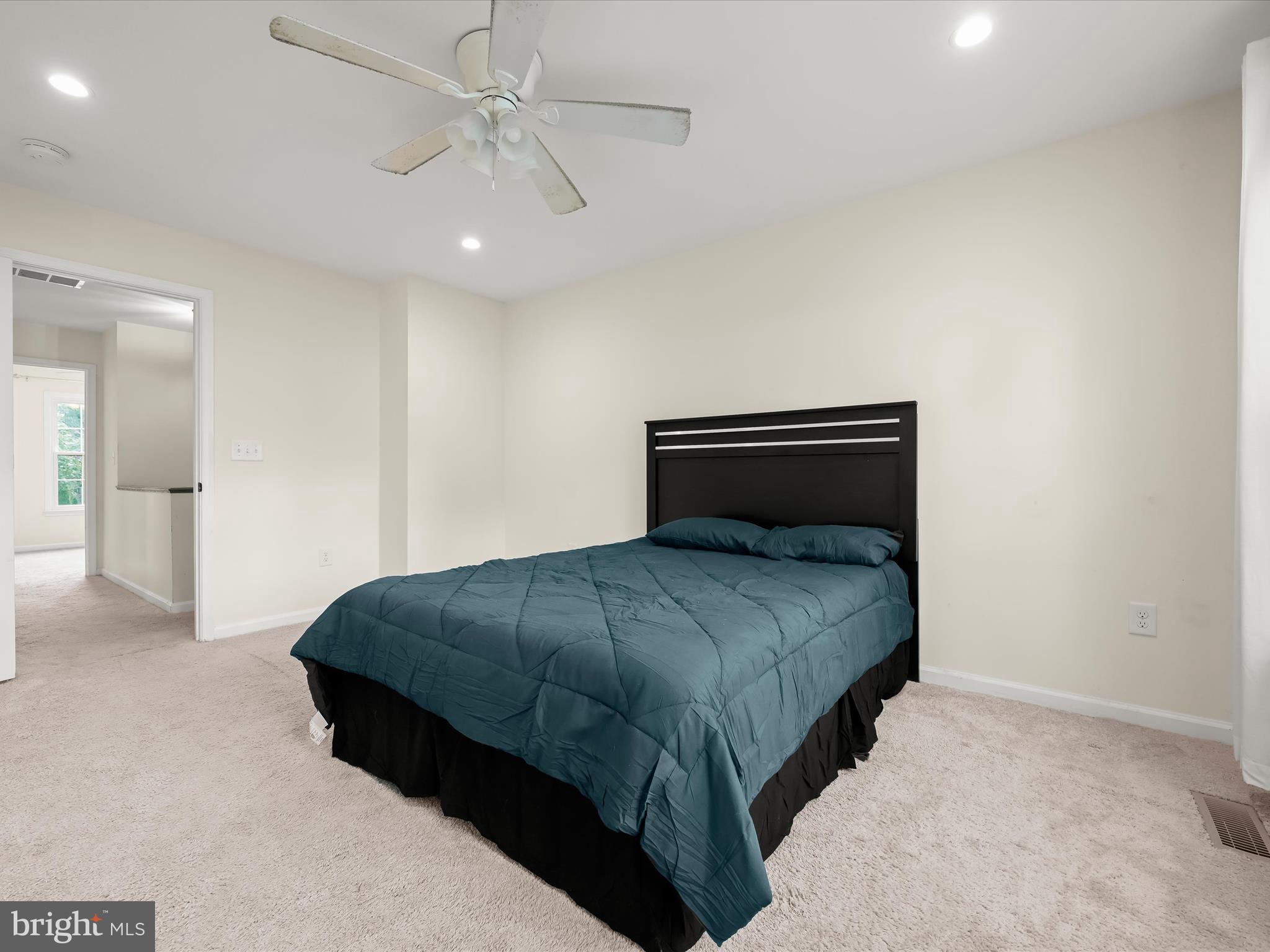 8806 Admiral Drive Laurel, MD 20708 - Photo 24 of 59 a bedroom with a bed and ceiling fan