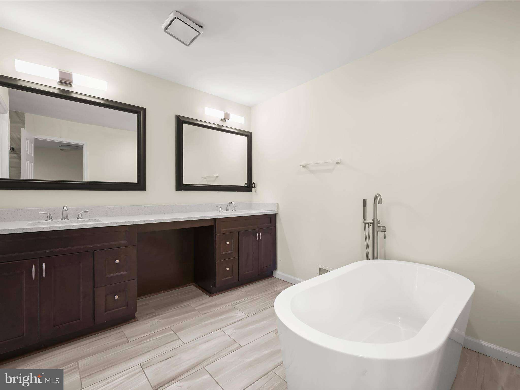 8806 Admiral Drive Laurel, MD 20708 - Photo 26 of 59 a bathroom with a tub sink and mirror